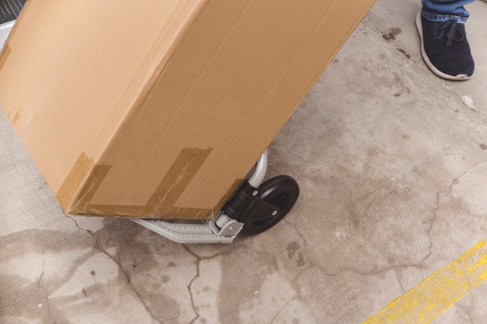 Close-up,Of,An,Individual,Using,A,Portable,Trolley,To,Move