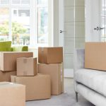 Cardboard,Carton,Boxes,Stack,With,Household,Belongings,In,Modern,House