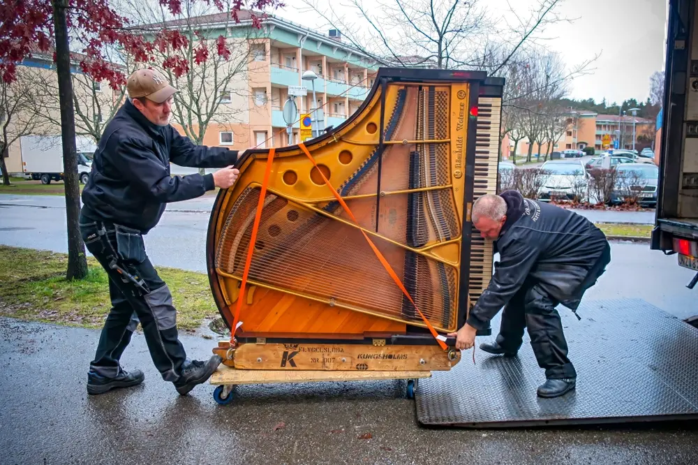 Professional piano moving in Round Rock, TX, with trained heavy item movers safely handling an upright piano