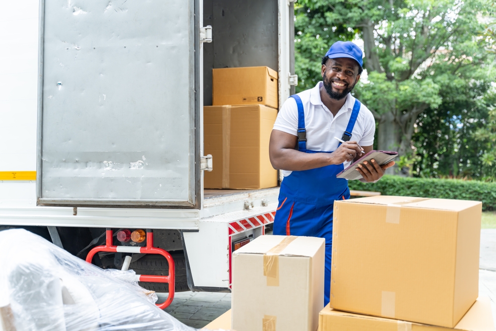 African,American,Workers,Unloading,Boxes,From,Van,Outdoors.moving,Service,Concept.male